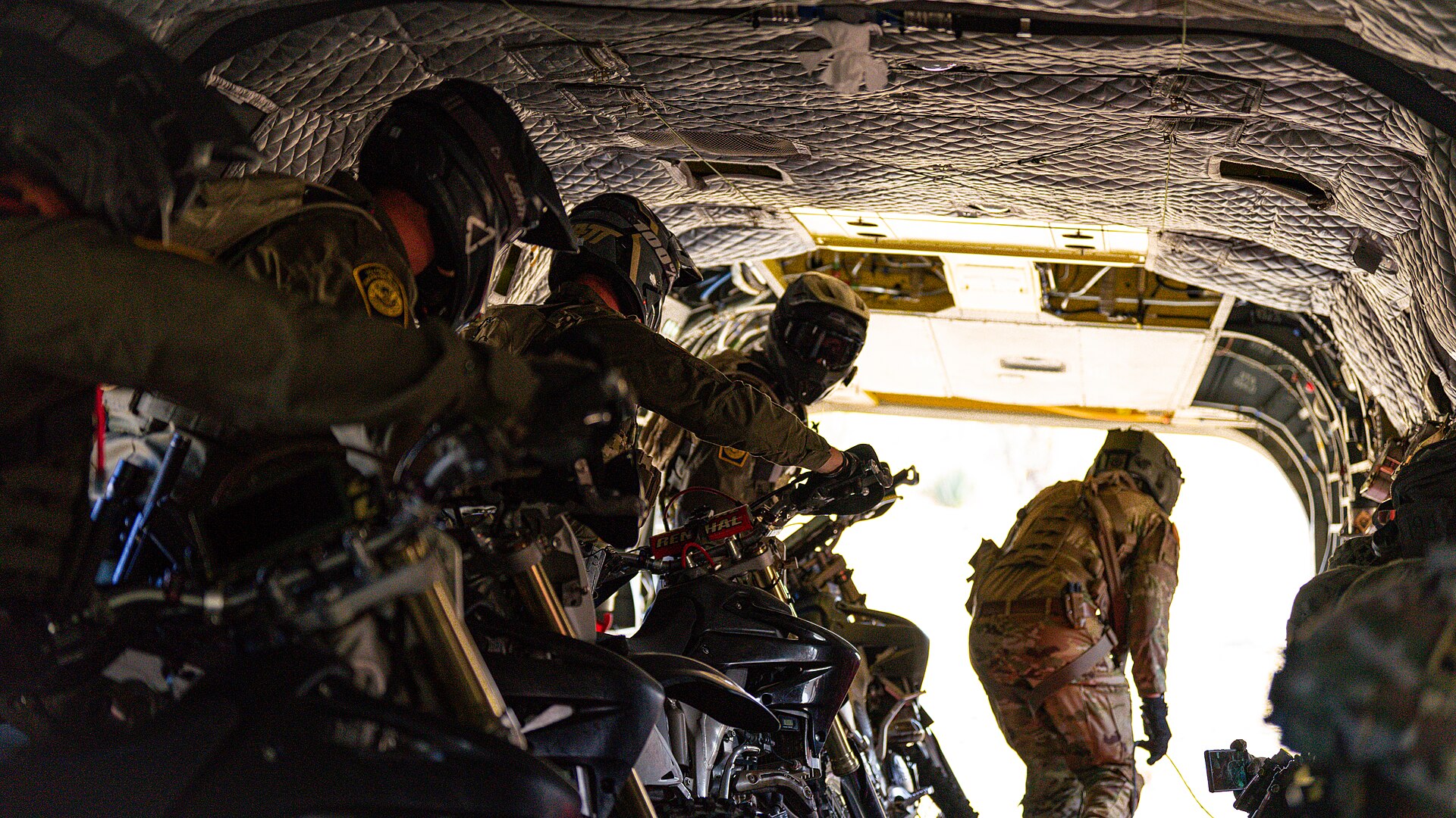 Soldiers and Border Patrol agents prepare to exit a CH-47 Chinook during an air insertion drill